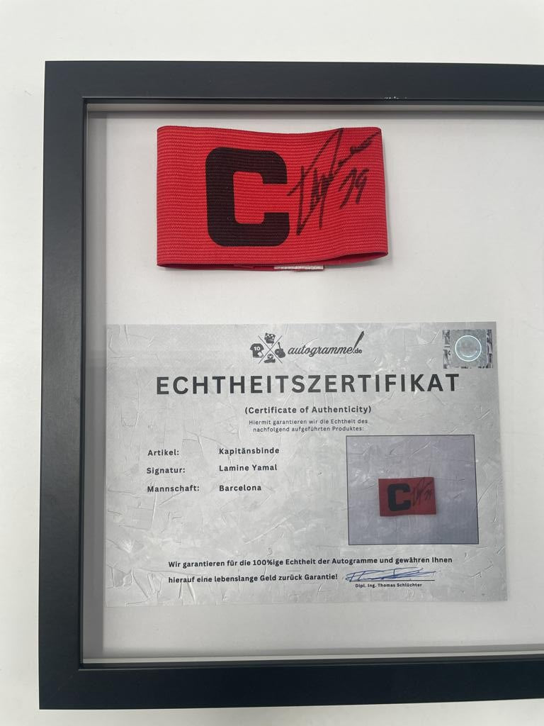 Captain's armband signed by Lamine Yamal in a framed FC Barcelona COA autograph