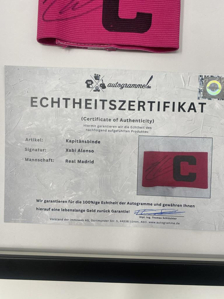 Captain's armband signed by Xabi Alonso in a Real Madrid football COA autograph frame