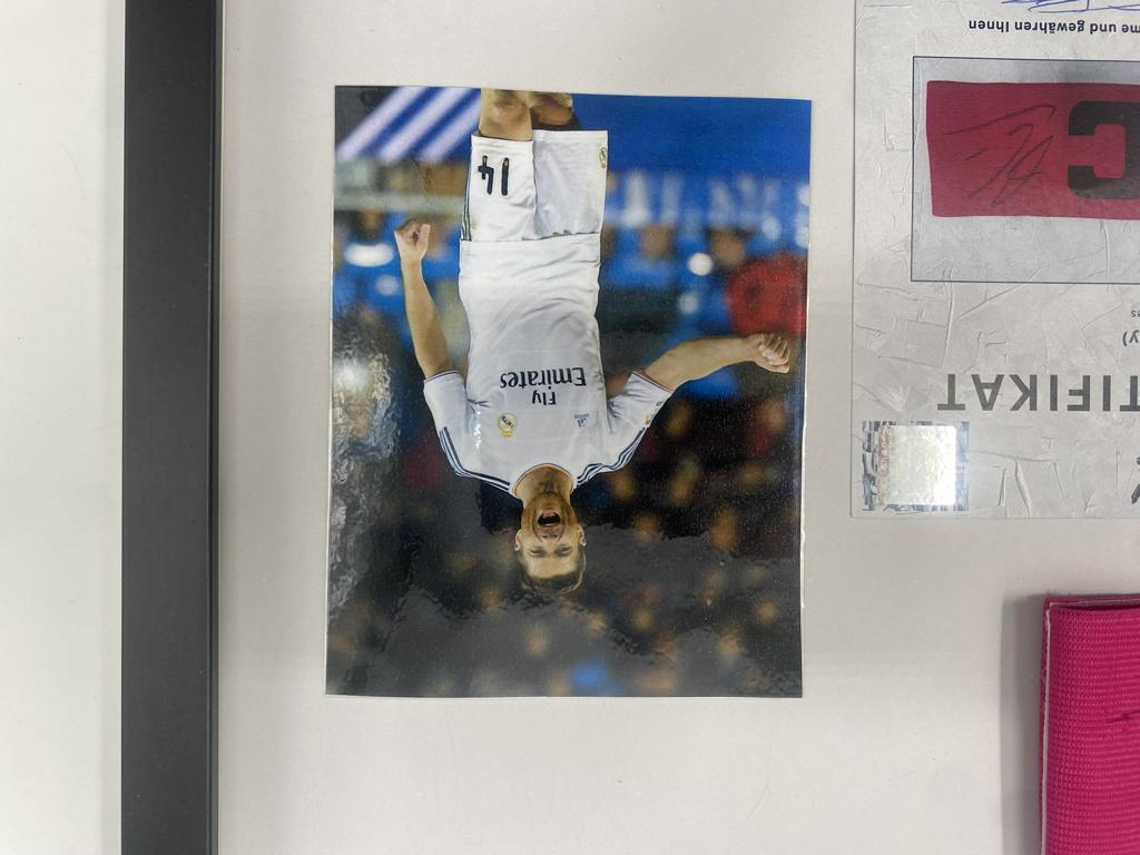 Captain's armband signed by Xabi Alonso in a Real Madrid football COA autograph frame