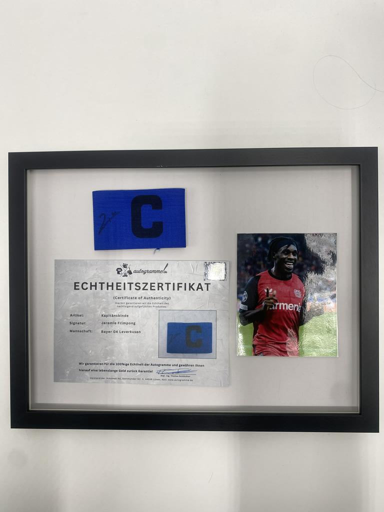 Captain's armband signed by Jeremie Frimpong in a frame, Bayer 04 Leverkusen autograph