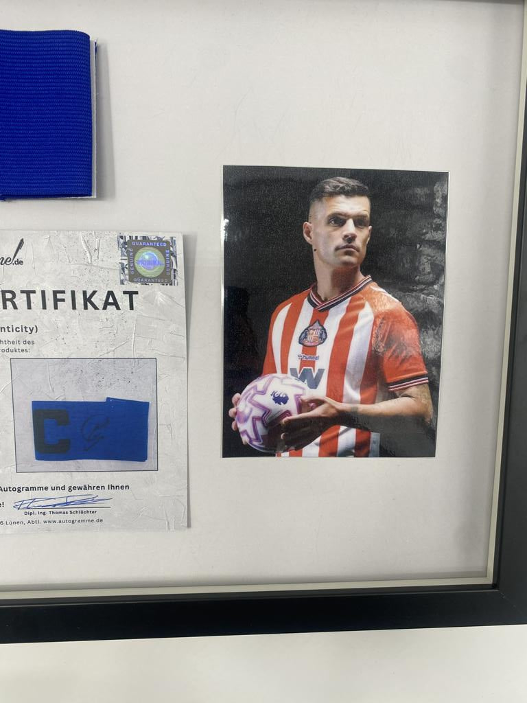 Captain's armband signed by Granit Xhaka in a frame, AFC Sunderland autograph