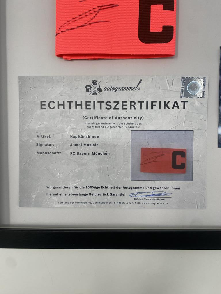 Captain's armband signed by Jamal Musiala in a Bayern Munich football autograph frame