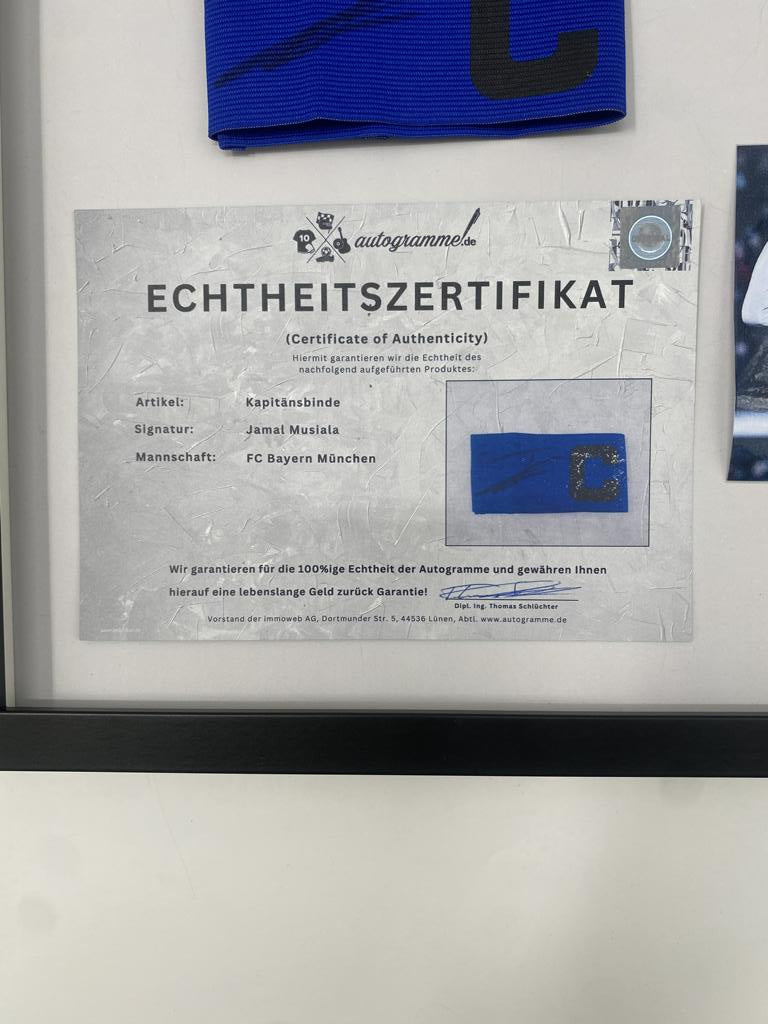 Captain's armband signed by Jamal Musiala in a Bayern Munich autograph frame