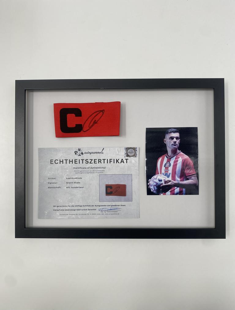 Captain's armband signed by Granit Xhaka in a frame, AFC Sunderland football autograph