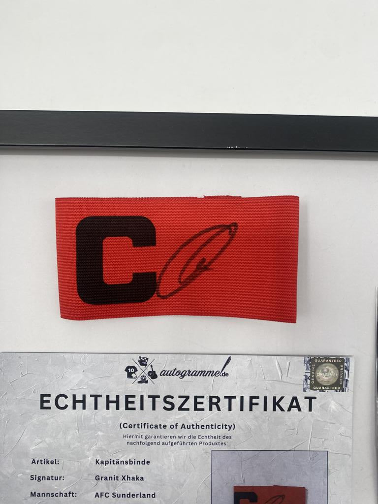 Captain's armband signed by Granit Xhaka in a frame, AFC Sunderland football autograph