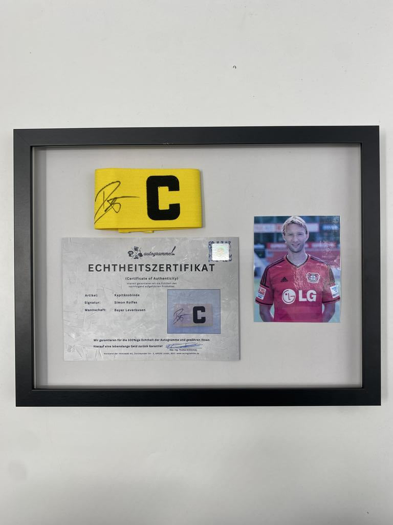 Captain's armband signed by Simon Rolfes in a frame, autographed by Bayer 04 Leverkusen