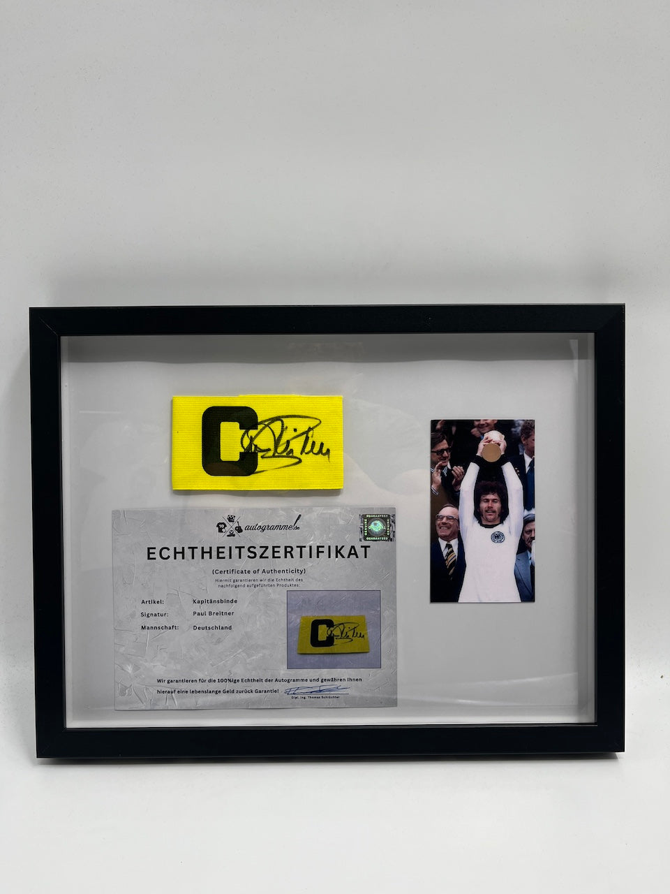 Captain's armband signed by Paul Breitner in a DFB football autograph COA frame