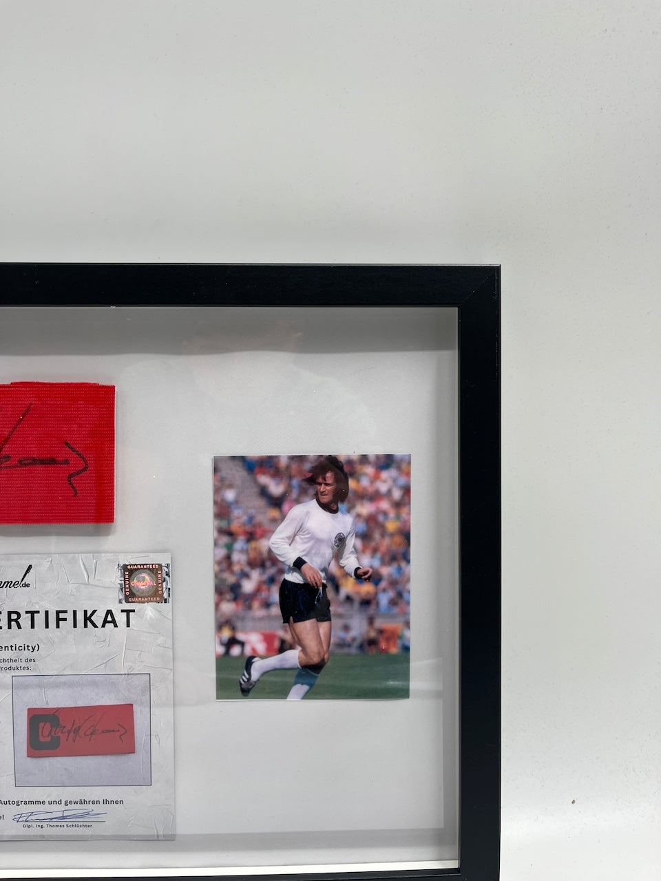 Captain's armband signed by Wolfgang Overath in a DFB football autograph COA frame