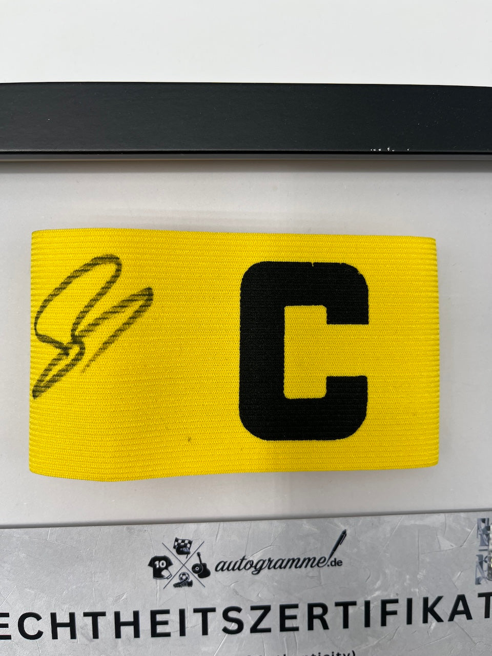 Captain's armband signed by Ramy Bensebaini in a Borussia Dortmund COA frame