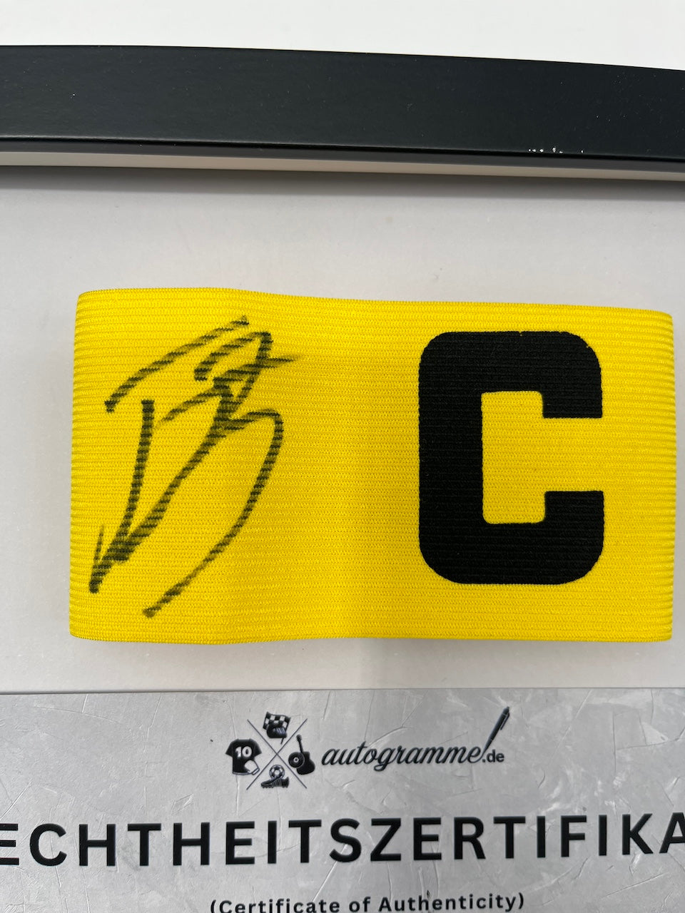 Captain's armband signed by Jobe Bellingham in a Borussia Dortmund COA frame