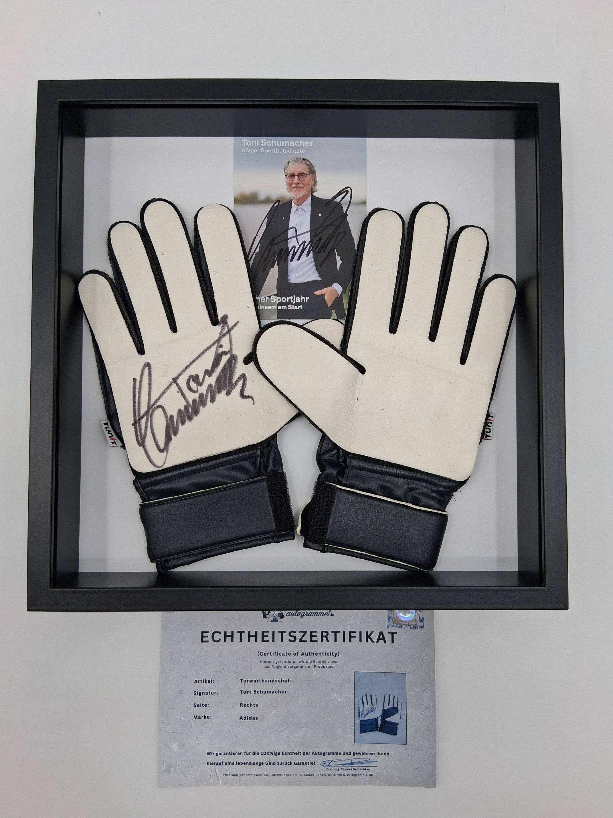 Goalkeeper glove signed by Toni Schumacher in a frame, autographed football