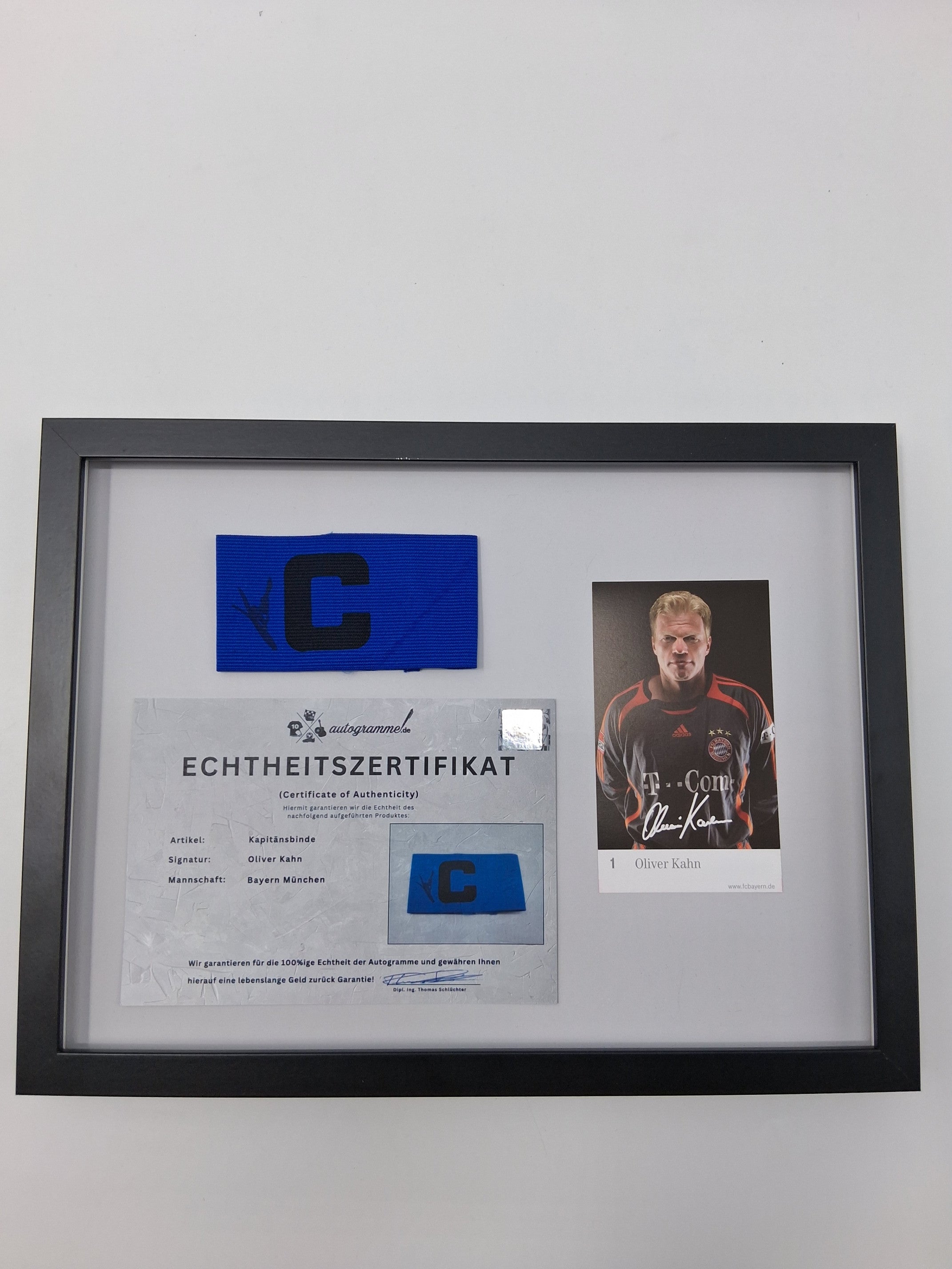 Captain's armband signed by Oliver Kahn in a Bayern Munich football autograph frame
