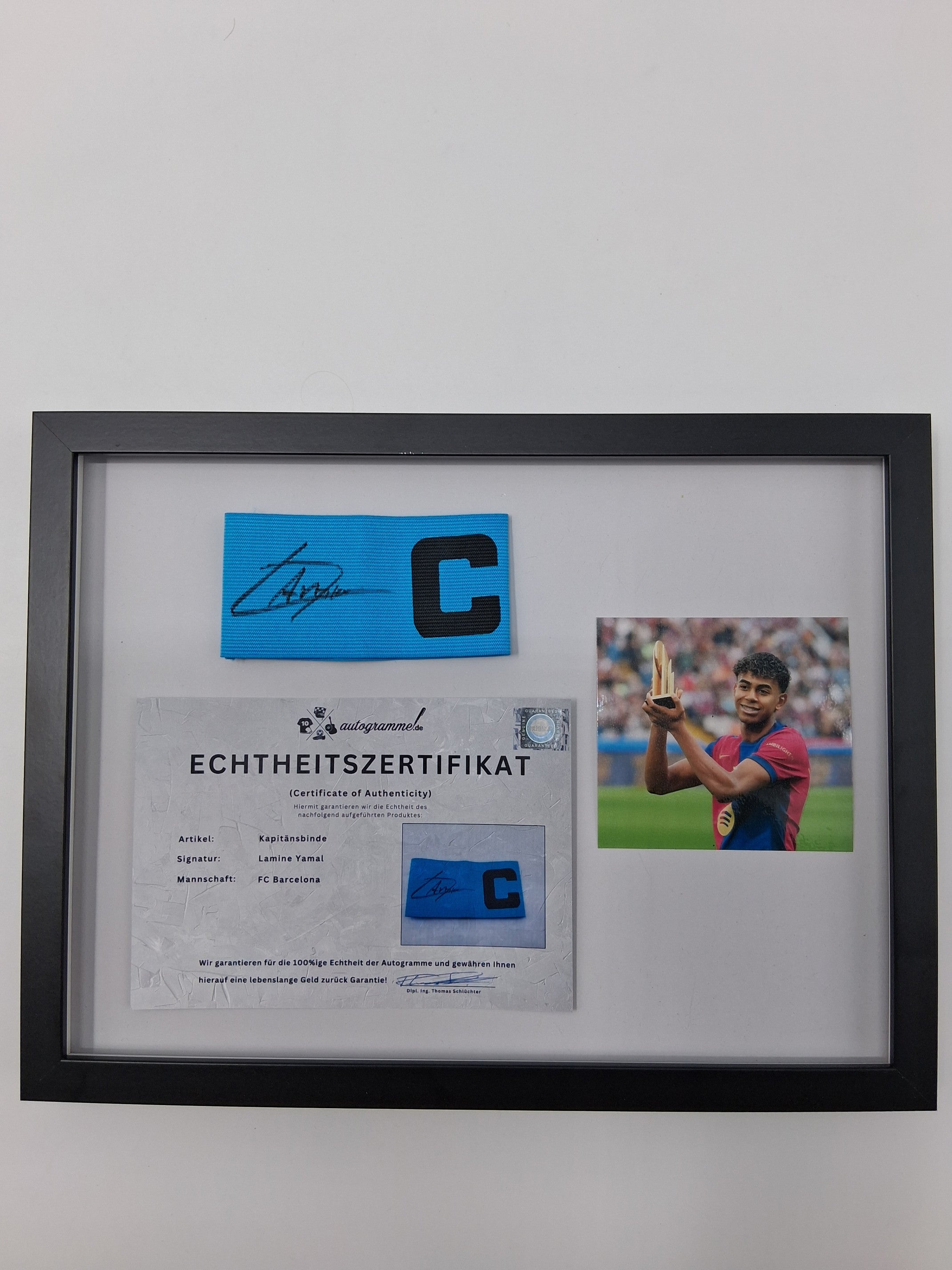 Captain's armband signed by Lamine Yamal in a framed FC Barcelona COA autograph