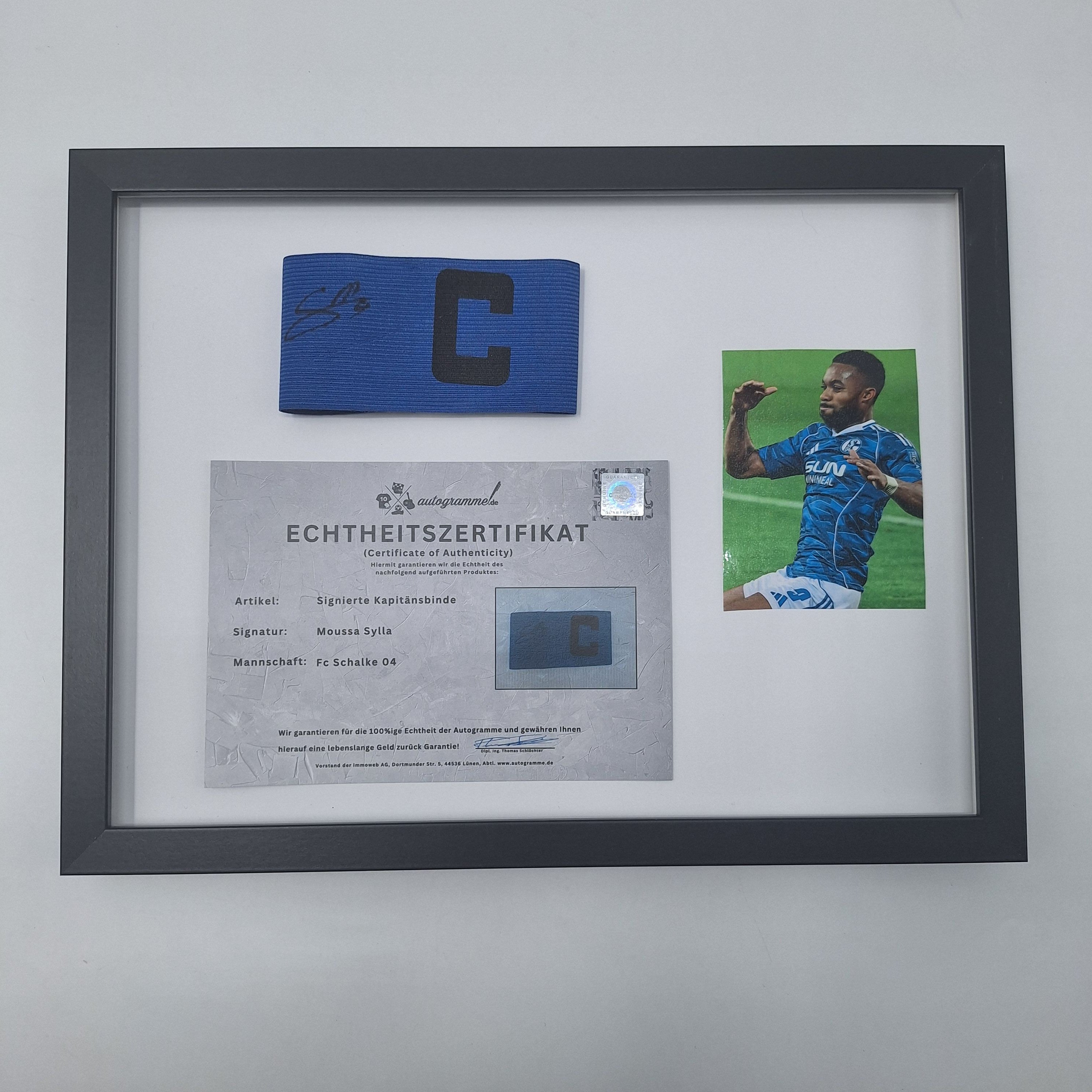Kapitänsbinde Moussa Sylla signiert im Rahmen Schalke 04 COA blau