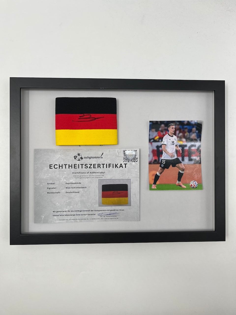 Captain's armband signed by Nico Schlotterbeck in a Germany COA frame