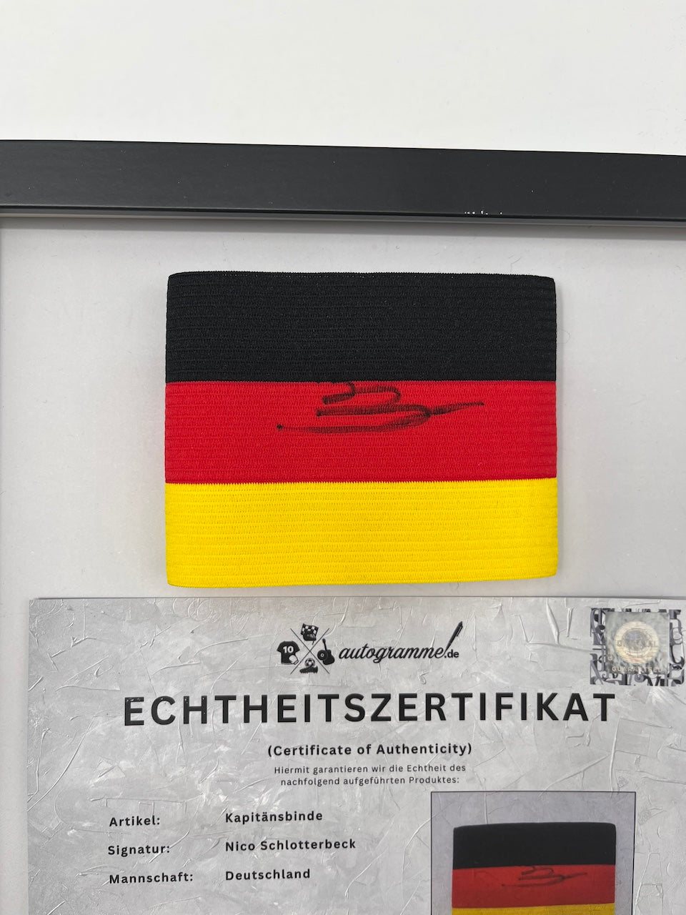 Captain's armband signed by Nico Schlotterbeck in a Germany COA frame