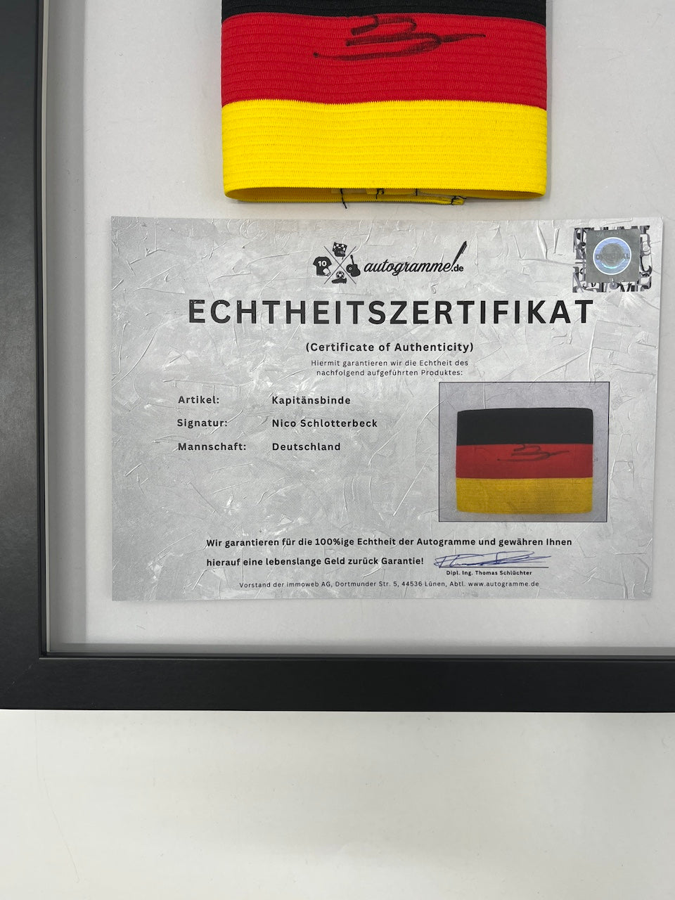 Captain's armband signed by Nico Schlotterbeck in a Germany COA frame