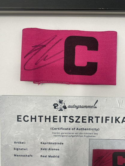 Captain's armband signed by Xabi Alonso in a Real Madrid football COA autograph frame