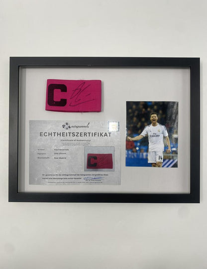 Captain's armband signed by Xabi Alonso in a Real Madrid football COA autograph frame