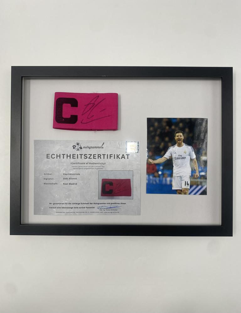 Captain's armband signed by Xabi Alonso in a Real Madrid football COA autograph frame