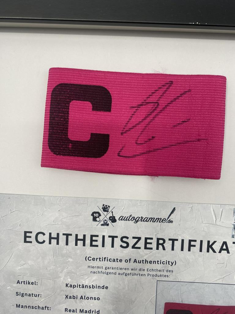 Captain's armband signed by Xabi Alonso in a Real Madrid football COA autograph frame