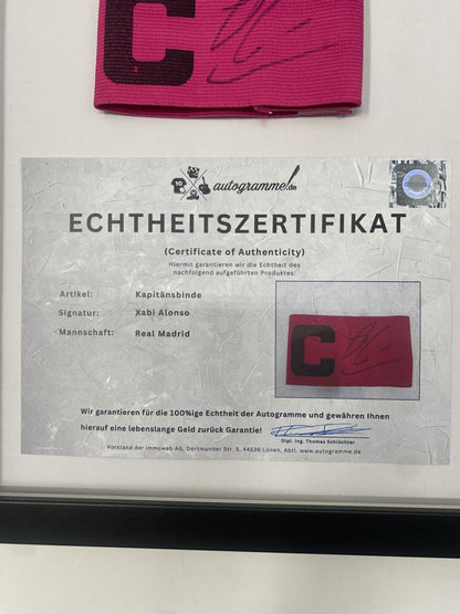 Captain's armband signed by Xabi Alonso in a Real Madrid football COA autograph frame