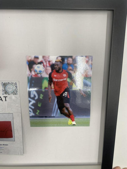 Captain's armband signed by Victor Boniface in a Bayer Leverkusen frame. Autograph