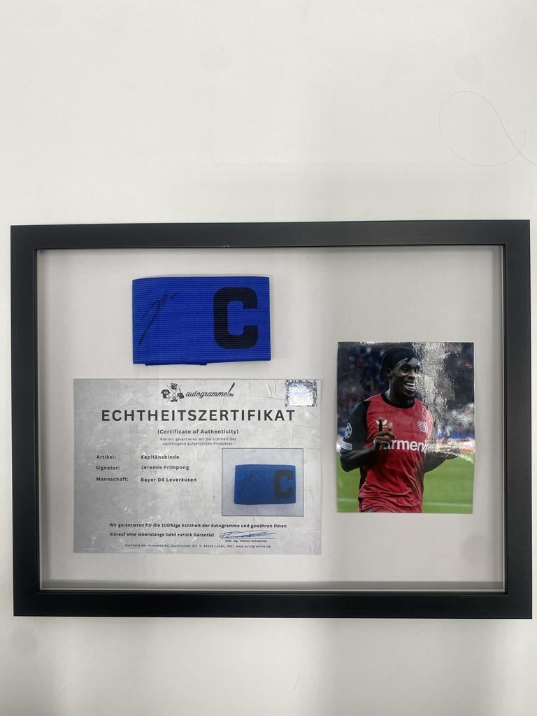 Captain's armband signed by Jeremie Frimpong in a frame, Bayer 04 Leverkusen autograph