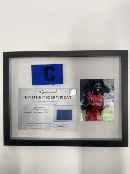 Captain's armband signed by Jeremie Frimpong in a frame, Bayer 04 Leverkusen autograph