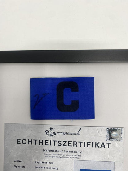 Captain's armband signed by Jeremie Frimpong in a frame, Bayer 04 Leverkusen autograph