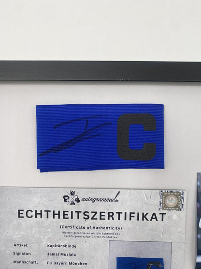 Captain's armband signed by Jamal Musiala in a Bayern Munich autograph frame