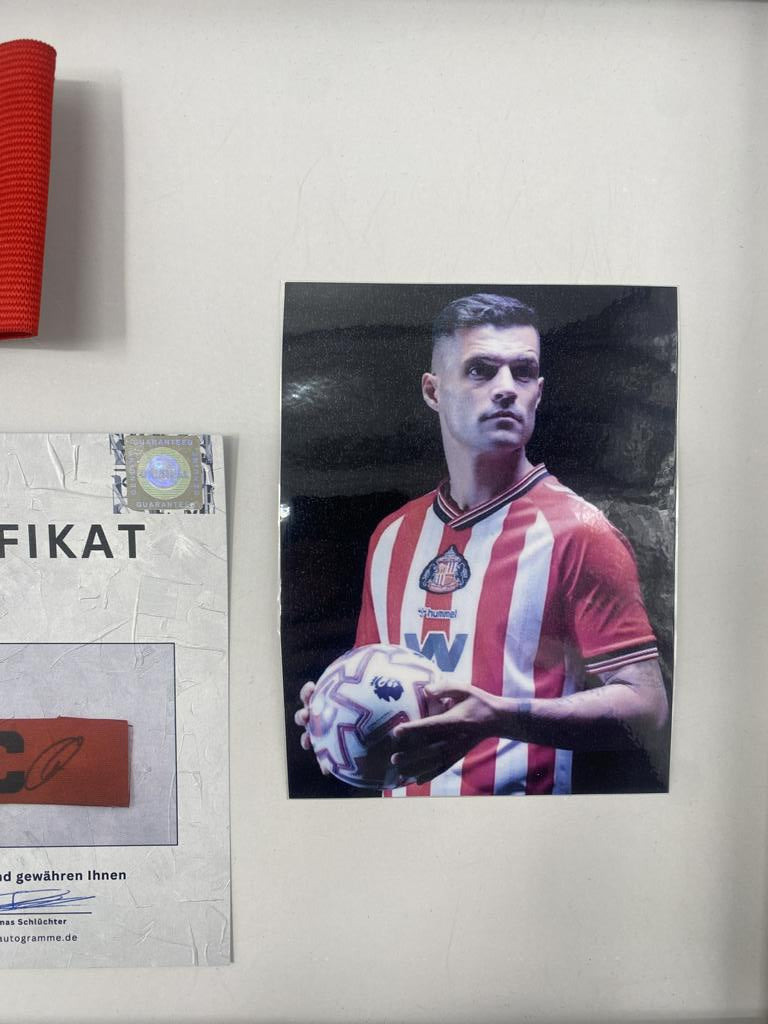 Captain's armband signed by Granit Xhaka in a frame, AFC Sunderland football autograph