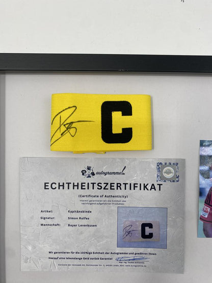 Captain's armband signed by Simon Rolfes in a frame, autographed by Bayer 04 Leverkusen