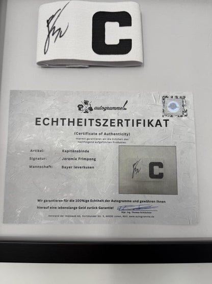 Captain's armband signed by Jeremie Frimpong in a frame, Bayer 04 Leverkusen autograph