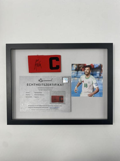 Captain's armband signed by Mohamed Amoura in a frame, Algeria Autograph COA