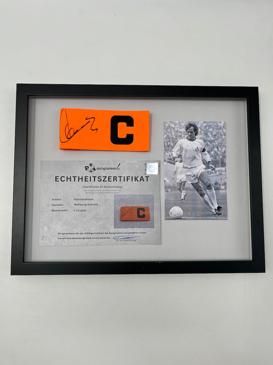 Kapitänsbinde Wolfgang Overath signiert im Rahmen Köln COA Autogramm