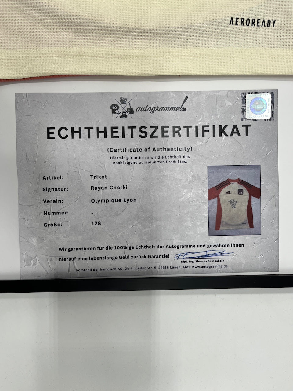 Olympique Lyon jersey signed by Rayan Cherki in an Adidas football frame, item number 128
