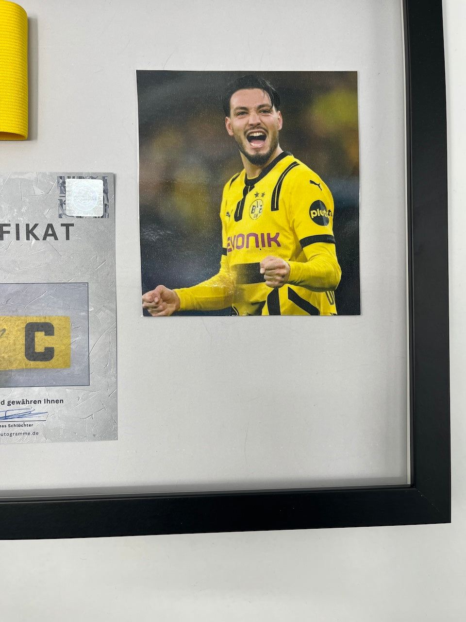 Captain's armband signed by Ramy Bensebaini in a Borussia Dortmund COA frame