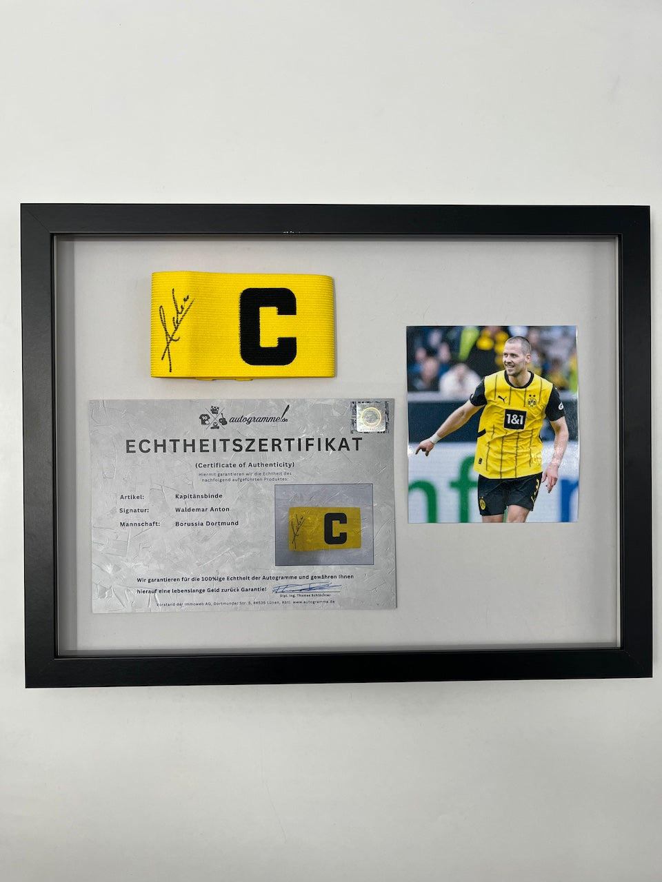 Captain's armband signed by Waldemar Anton in a Borussia Dortmund COA frame