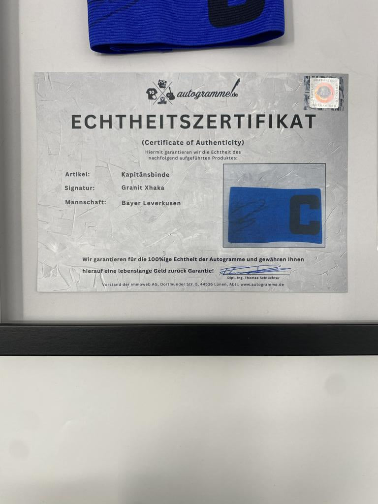 Captain's armband signed by Granit Xhaka in a frame, Bayer Leverkusen autograph