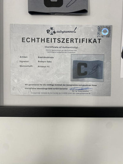 Captain's armband signed by Bukayo Saka in a frame, Arsenal FC autograph