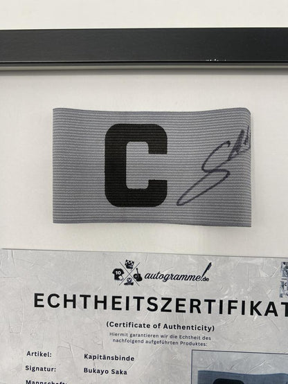 Captain's armband signed by Bukayo Saka in a frame, Arsenal FC autograph