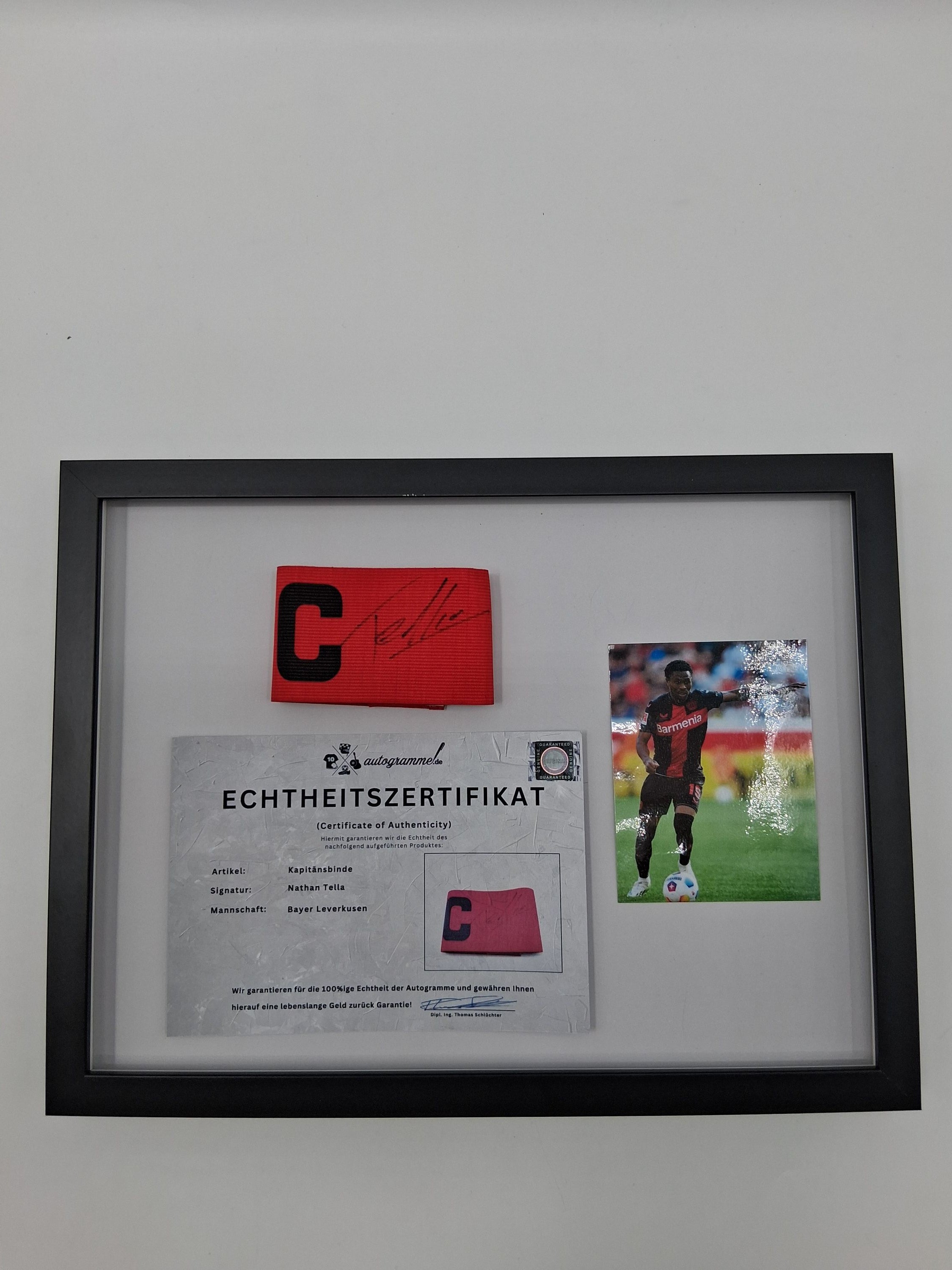 Captain's armband signed by Nathan Tella in a Bayer Leverkusen autograph frame